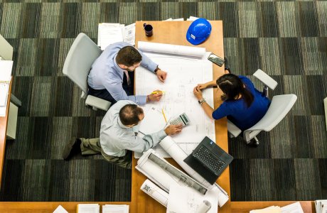 three people meeting at a table