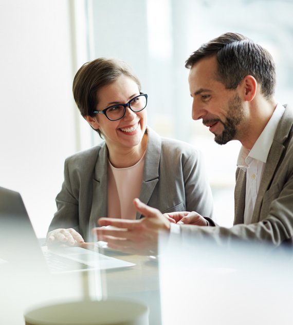 two people talking at conference table