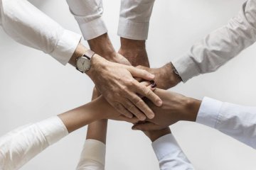 Team members performing a hand-stacking ritual