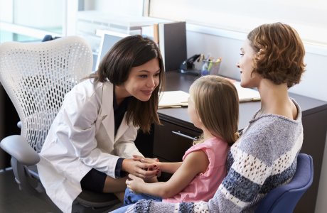 Healthcare worker with mother and child